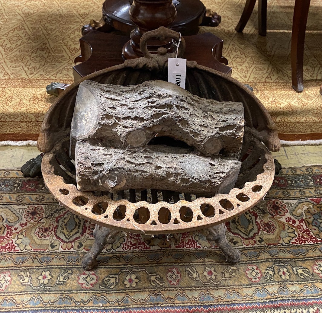 A Victorian cast iron fire grate, width 44cms and a plaster faux log stack.